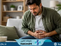 تصویری از یک فرد با احساس نفخ و ناراحتی شکم که اهمیت سلامت دستگاه گوارش و عادت های غذایی صحیح را نشان می دهد.